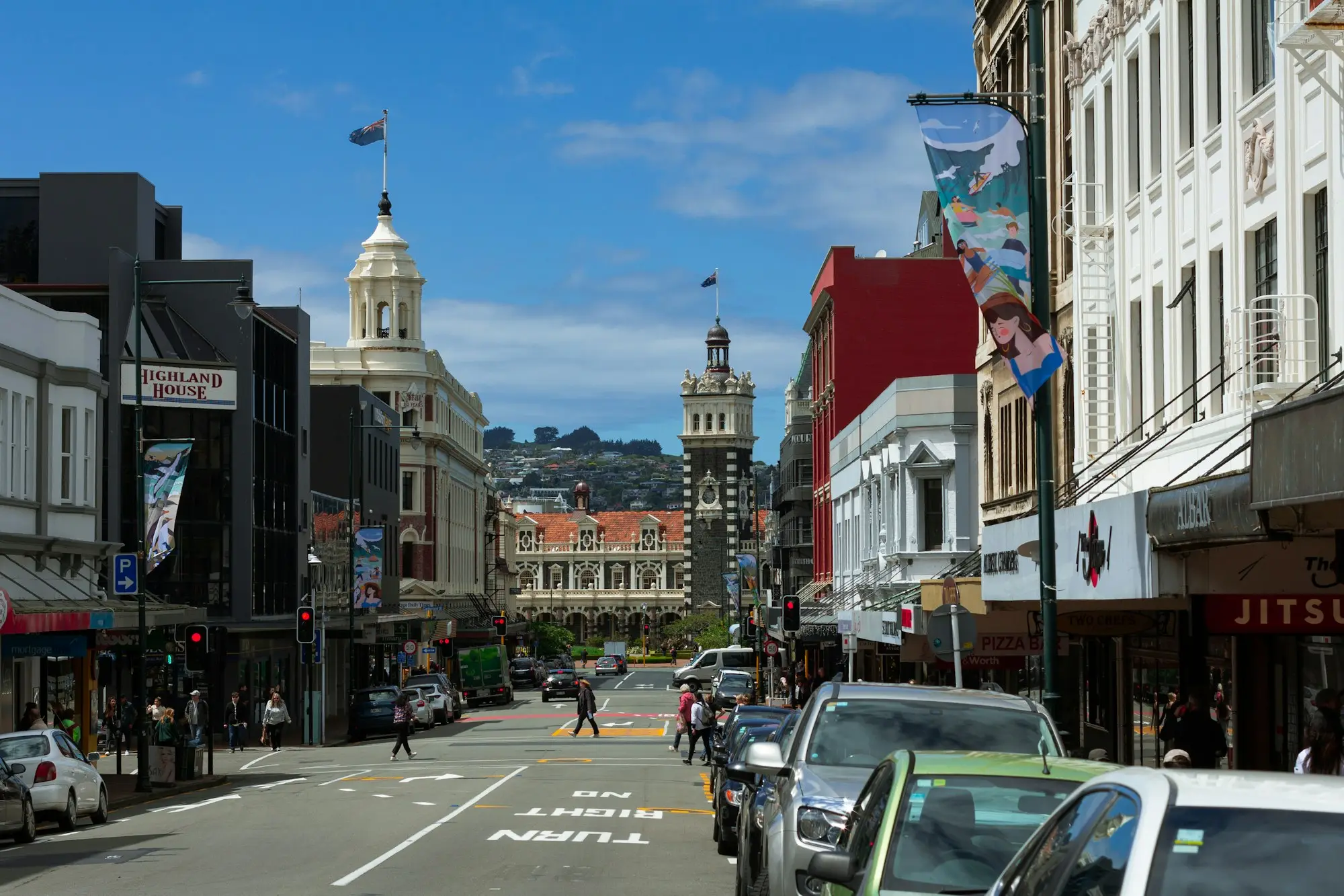 City street lined with buildings and parked cars