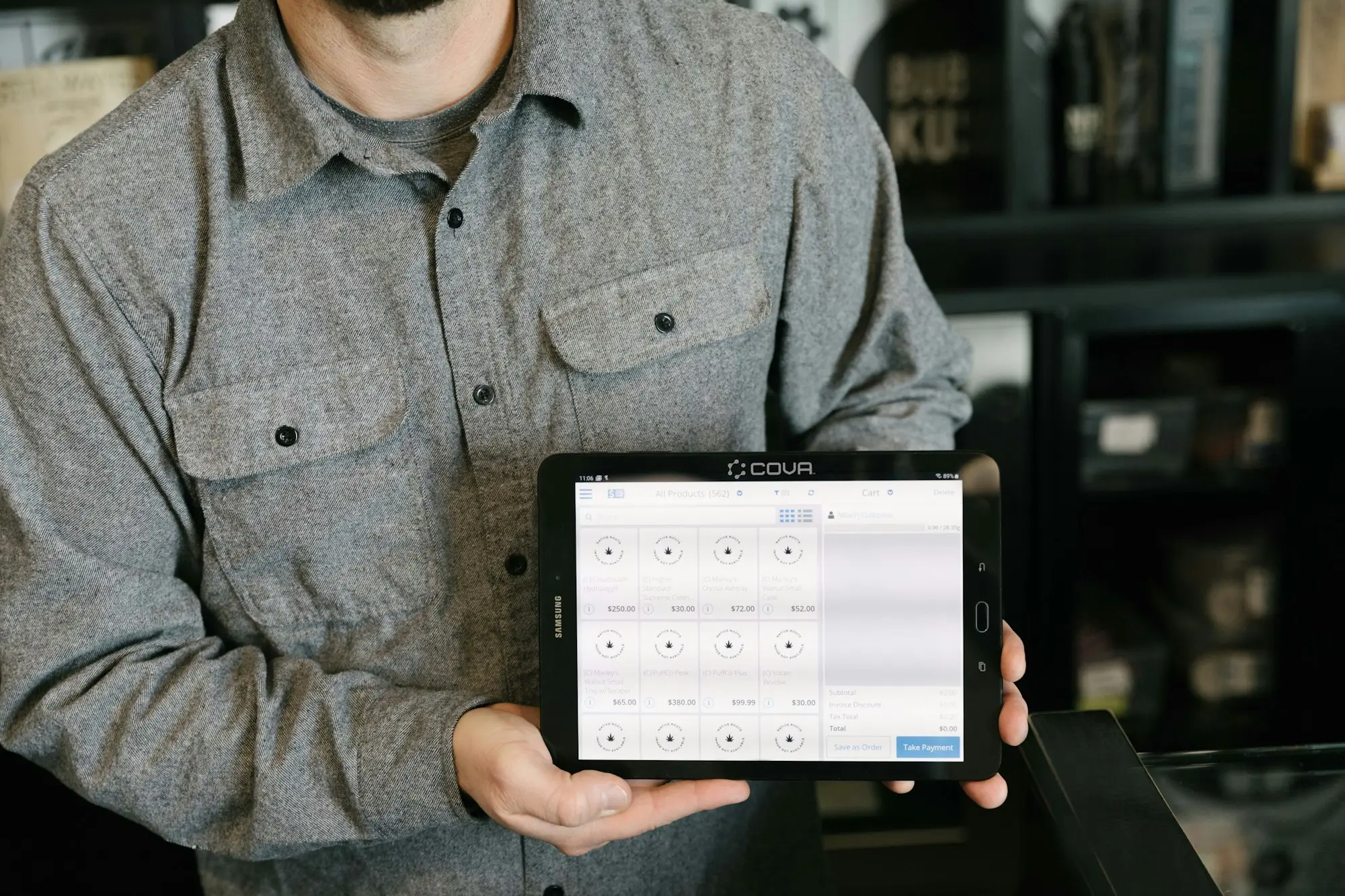 Man holding a tablet showing stock figures